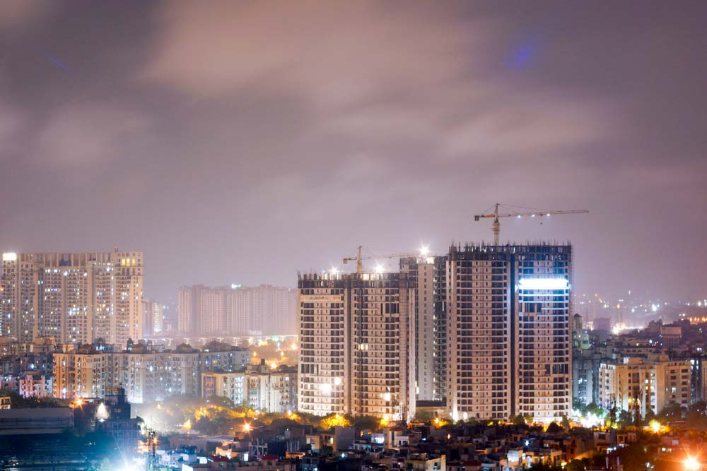 Night image of a city where high-rise buildings are being constructed. Photo.