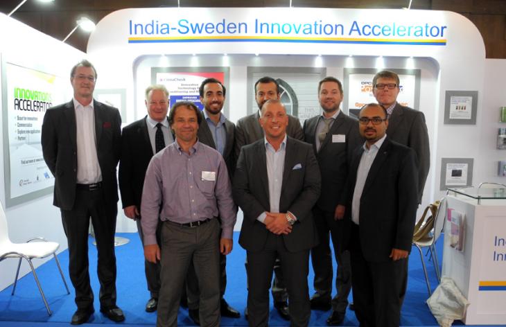 Nine men at the Innovations Accelerator stand. Photo.