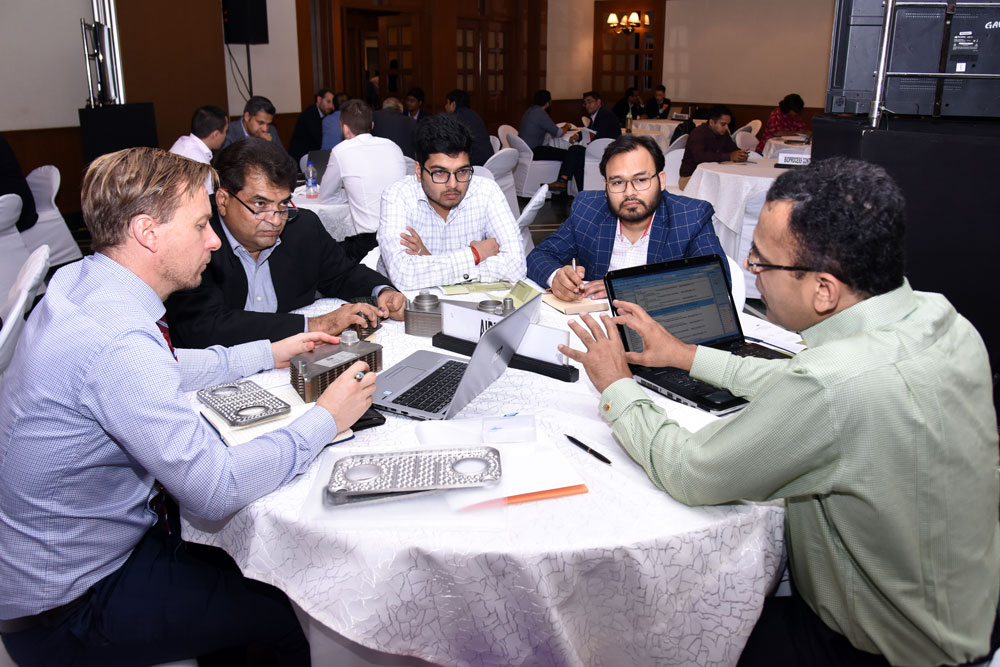 Business men with laptops during speed business meetings in Delhi.